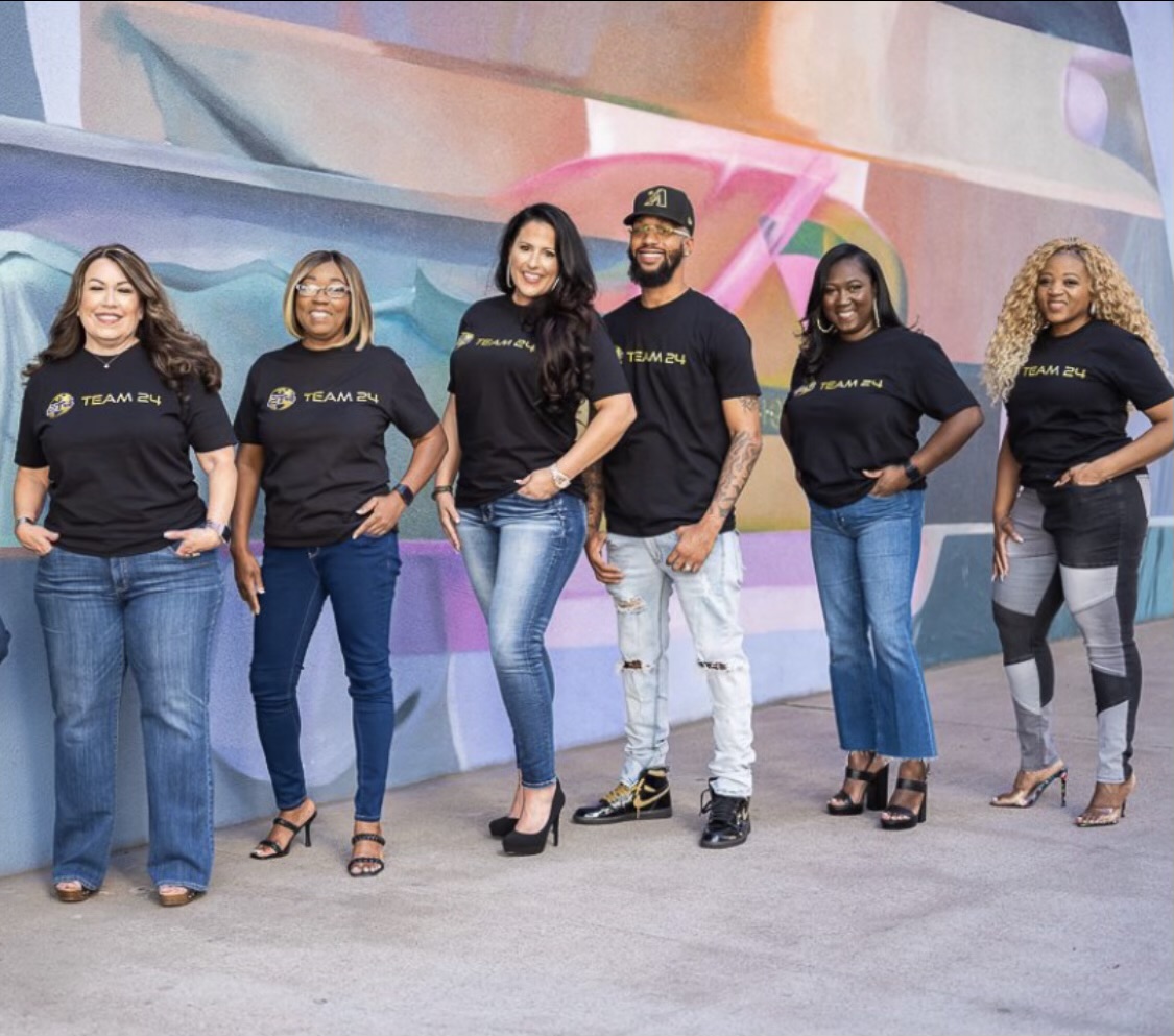 A Group of People Posing in Team 24 Black Shirts