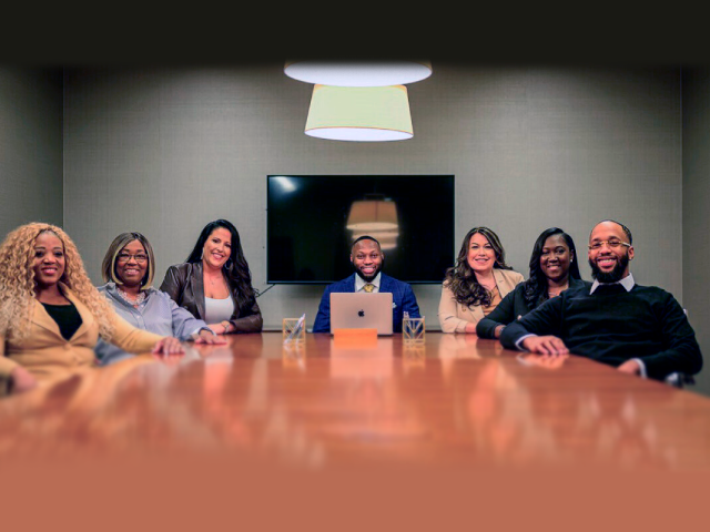 A group of people sitting around a table.