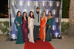 A group of people standing on the red carpet