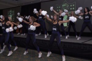 A group of cheerleaders perform on stage.