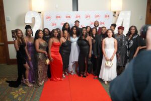 A group of people standing on the red carpet