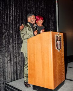 A man and woman standing at the podium