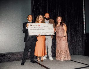 A group of people holding up a giant check.