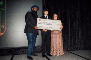 A man and woman holding a giant check