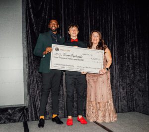 A group of people holding up a giant check.