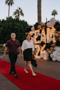 A man and woman walking on the red carpet