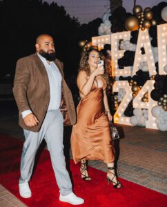 A man and woman walking on the red carpet