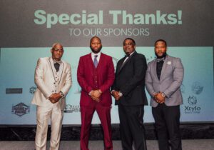 Four men in suits and ties standing next to each other.