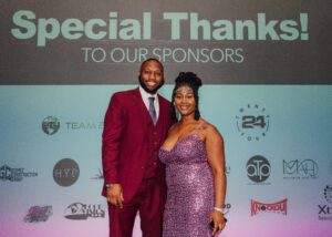 A man and woman posing for a picture at an event.