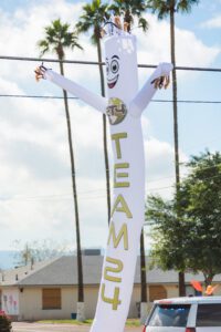 A white and gold inflatable man with the word " team 2 " on it.