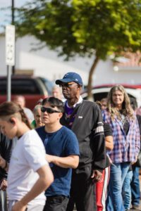 A group of people standing in line at an event.