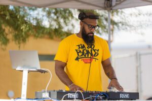 A man with a beard and glasses is playing some music