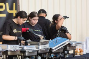 A group of people working on some metal.