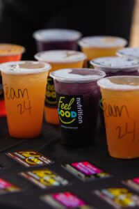 A table with several cups of drinks on it.