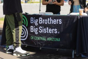 A table with a sign that says big brothers, big sisters of central arizona.