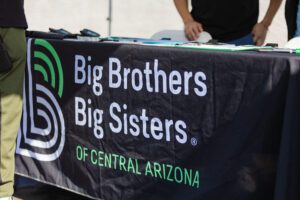 A table with a big brothers and sisters sign on it