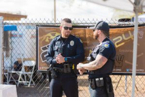 Two police officers talking to each other outside.