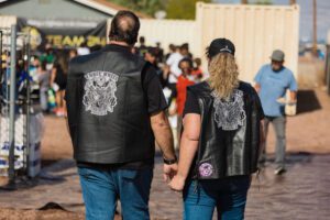 A man and woman holding hands while walking.