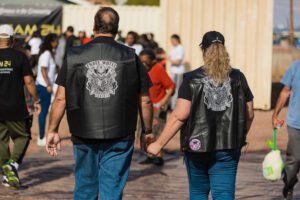 A man and woman holding hands while walking.