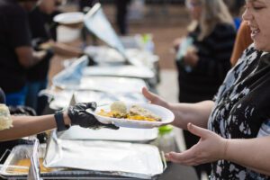 A person is serving food from a plate.