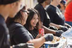 A group of people sitting around eating food.