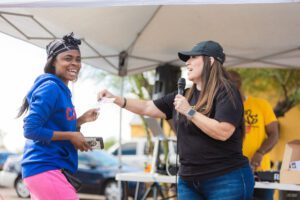 Two women are having a conversation at an event.