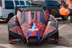 A car with a woman on the hood