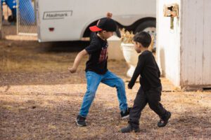 Two young boys playing a game of frisbee.