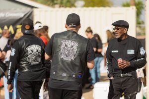 A group of men in black jackets and hats.