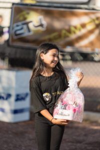 A girl holding a large bag of candy.