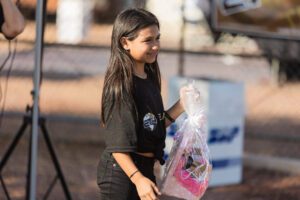 A girl holding onto some plastic bags