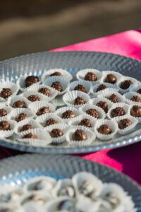 A silver tray with some chocolate covered candies