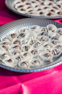 A silver plate with some chocolate covered candies