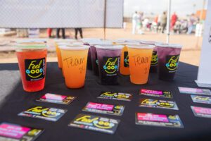 A table with cups of juice and cards