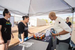 A woman standing next to a man at an outdoor event.