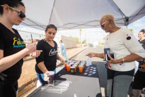 A woman is serving drinks to people.