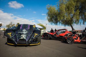 A couple of cars parked on top of a road.