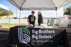 A man and woman standing under a tent.