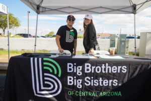 A man and woman standing under a tent.