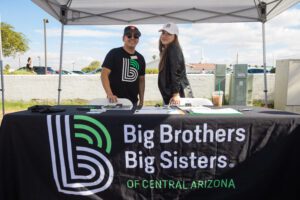 A man and woman standing under a tent.