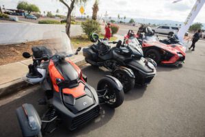 A row of motorcycles parked on the side of a road.