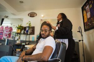 A man getting his hair cut in a barber shop.