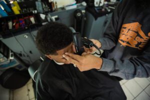 A man getting his hair cut at the barber shop