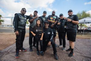 A group of people in black jackets posing for the camera.