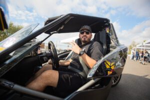 A man in the passenger seat of a car.