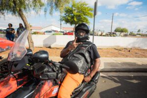 A man on a motorcycle with his helmet on.