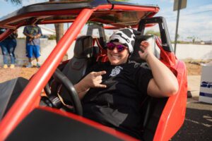 A man in the driver 's seat of an atv.