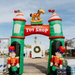 A toy shop arch with a horse on top of it.