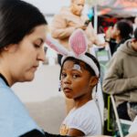 A woman and child with bunny ears on their head.