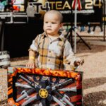 A young boy holding onto some toy tools